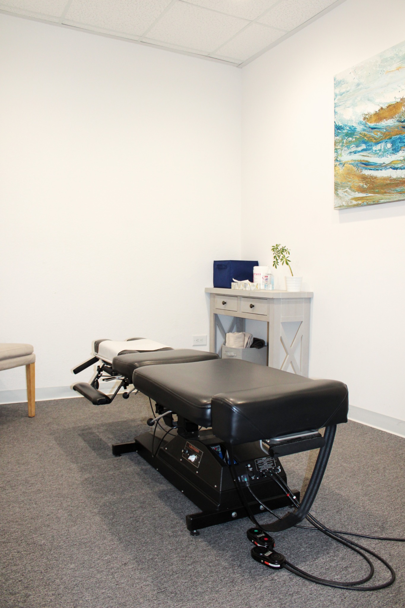 Treatment room with a chiropractic table